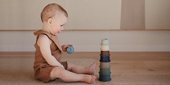 mushie muslin bibs with baby