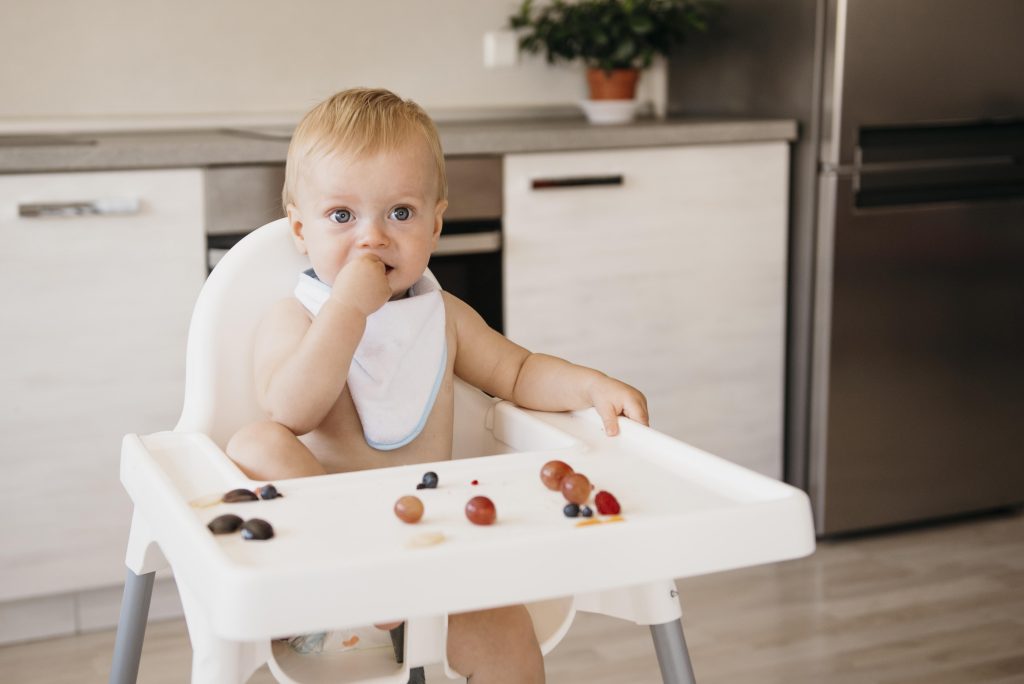 front-view-cute-baby-eating-alone